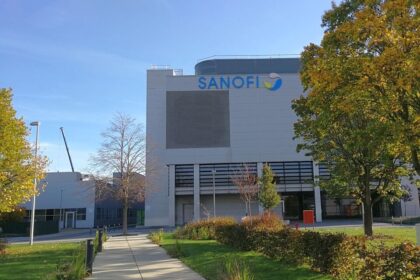 A modern industrial building with the Sanofi logo