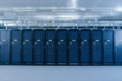 A room with rows of server racks in a data center.