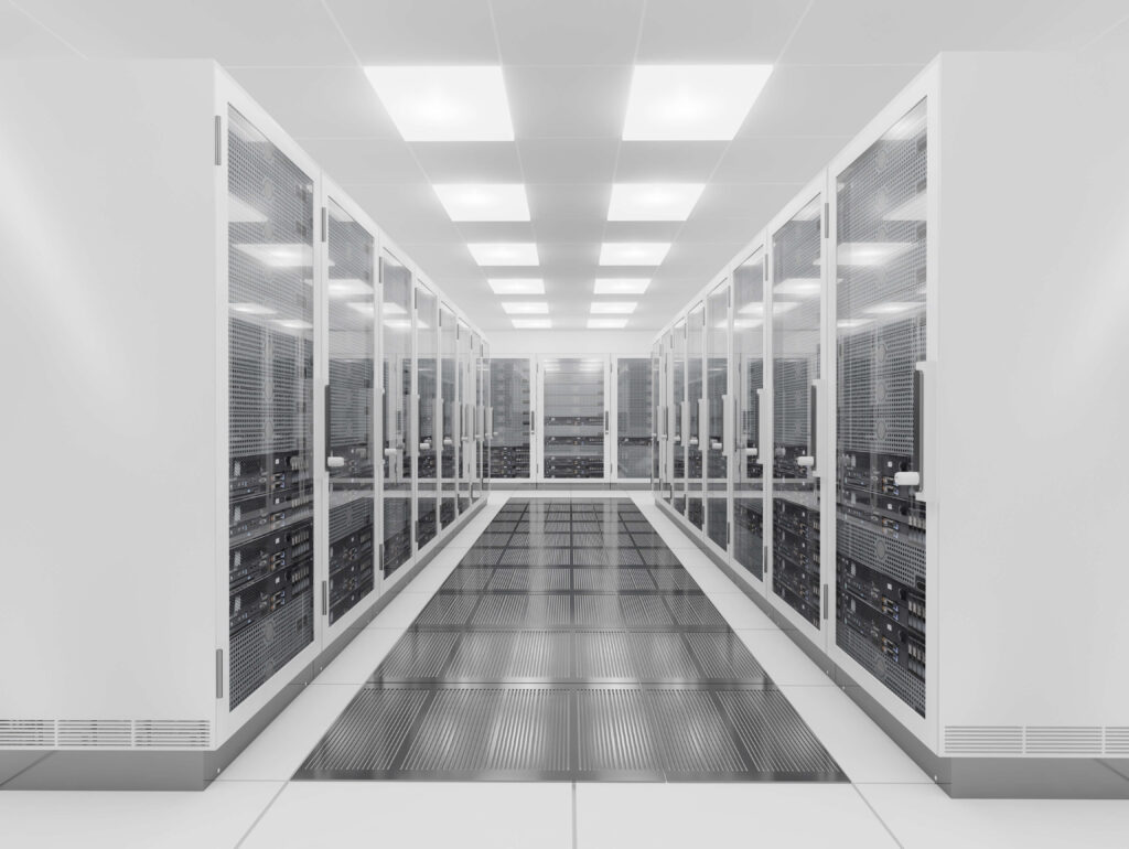 A room with rows of server racks in a data center.