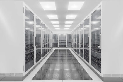 A room with rows of server racks in a data center.