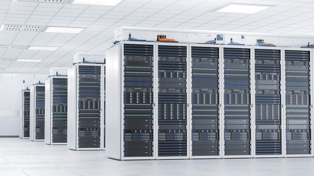 A room with rows of server racks in a data center.