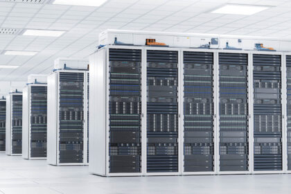 A room with rows of server racks in a data center.