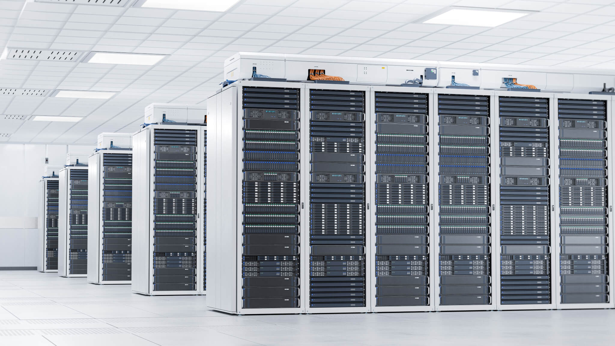 A room with rows of server racks in a data center.