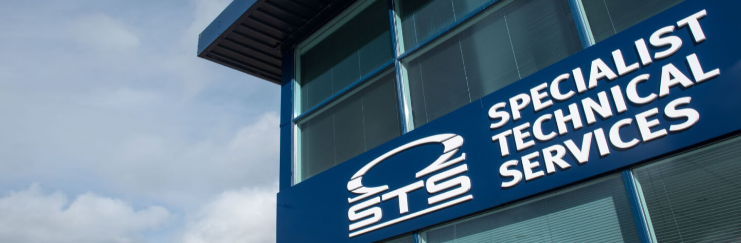 A building with a "Specialist Technical Services (STS)" sign.