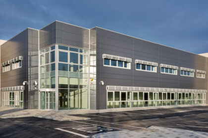 A modern, gray office building with large windows.