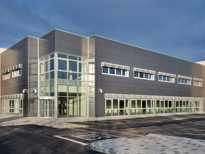 A modern, gray office building with large windows.