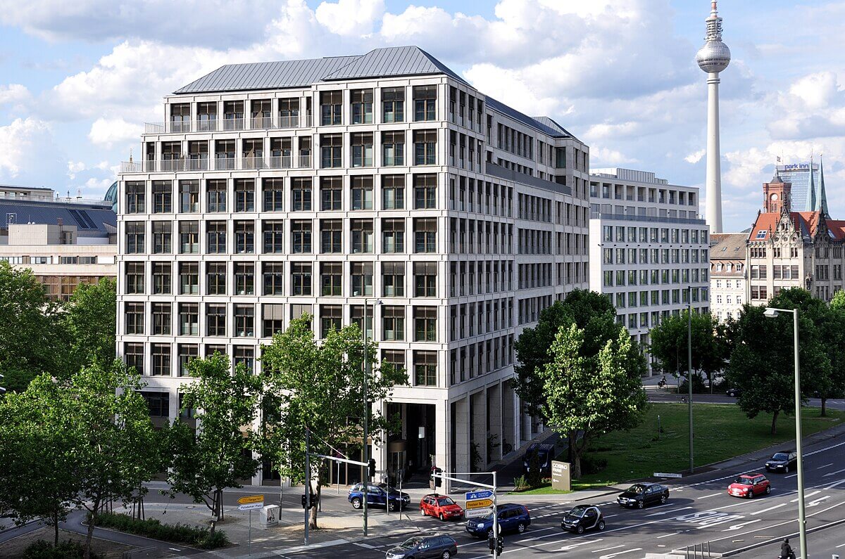 A large office building in Berlin with the Fernsehturm tower in the background.